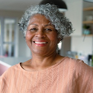 Closeup of woman smiling in kitchen