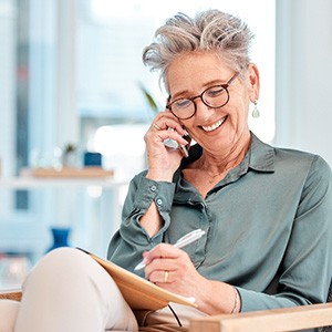 Woman smiling while talking on phone at home