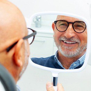 A man smiling at his new dentures