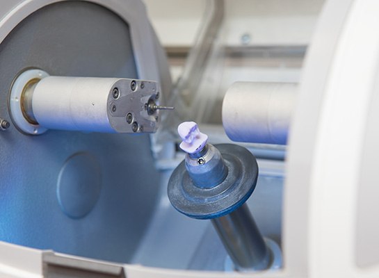 Closeup of a CEREC dental crown in milling machine