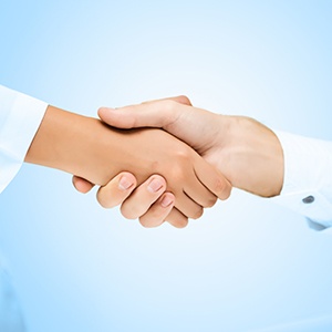 Close-up of patient shaking dentist’s hand