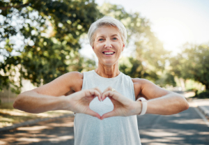 Senior woman making heart shape with hands