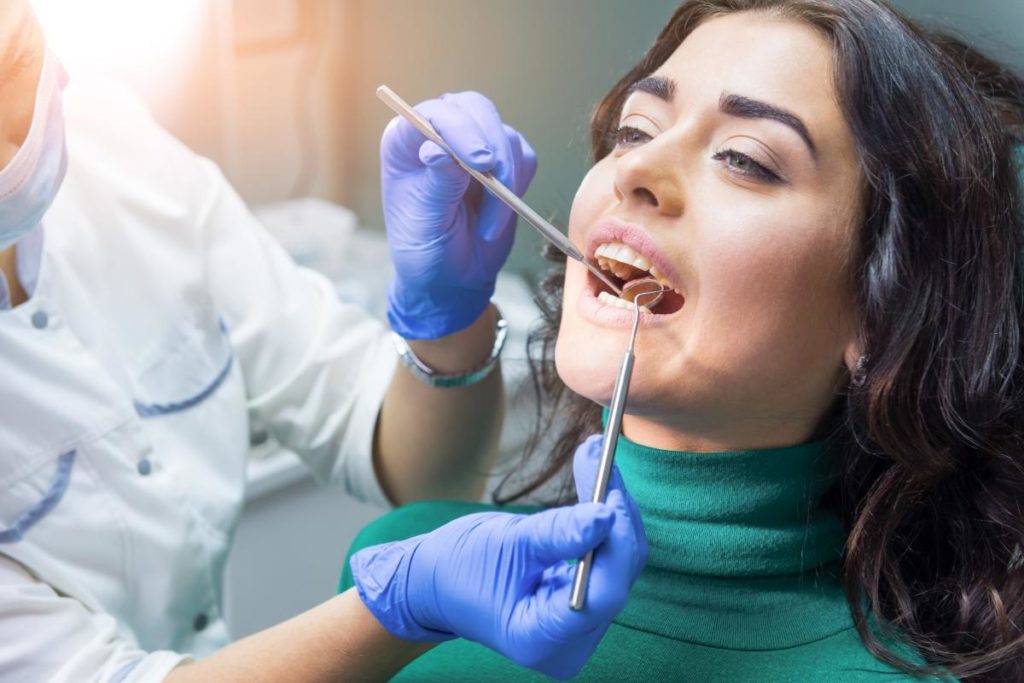 a dentist conducting a dental filling treatment in a patient's mouth