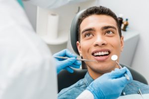 a patient is about to undergo some cosmetic dental services and is listening to his dentist before they start about the procedure